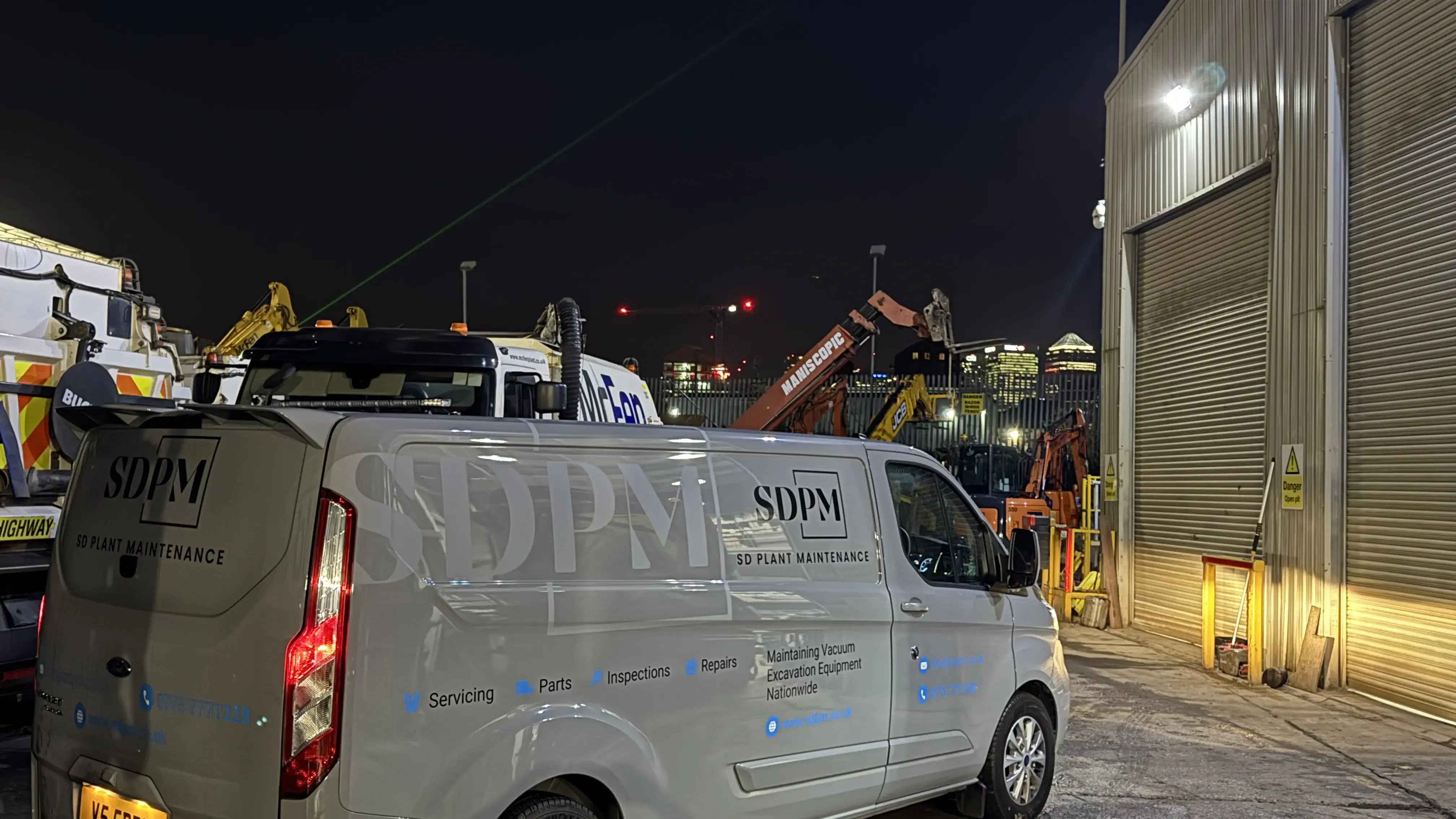 Mobile repair van parked beside excavator for on-site maintenance